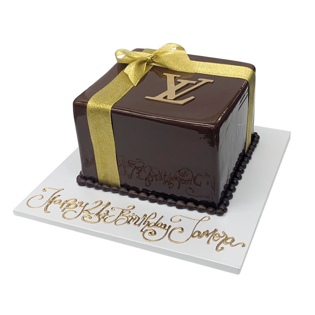 The Flour Girl Bakeshop - A Louis Vuitton inspired birthday cake, trimmed  with roses, caramel macarons, and Ferraro Rocher chocolates. #louisvuitton  #luxurybrand #birthdaycake #macarons #ferrerorocher #homemade #flourgirlvt  #homebakery #gourmetcakes